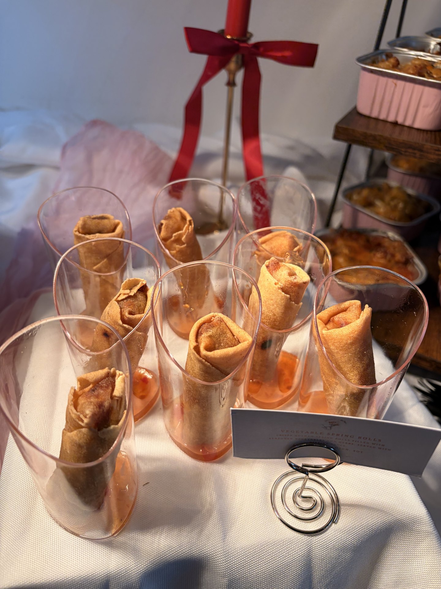 Spring rolls served in individual glasses on a KezzyKooks celebration table