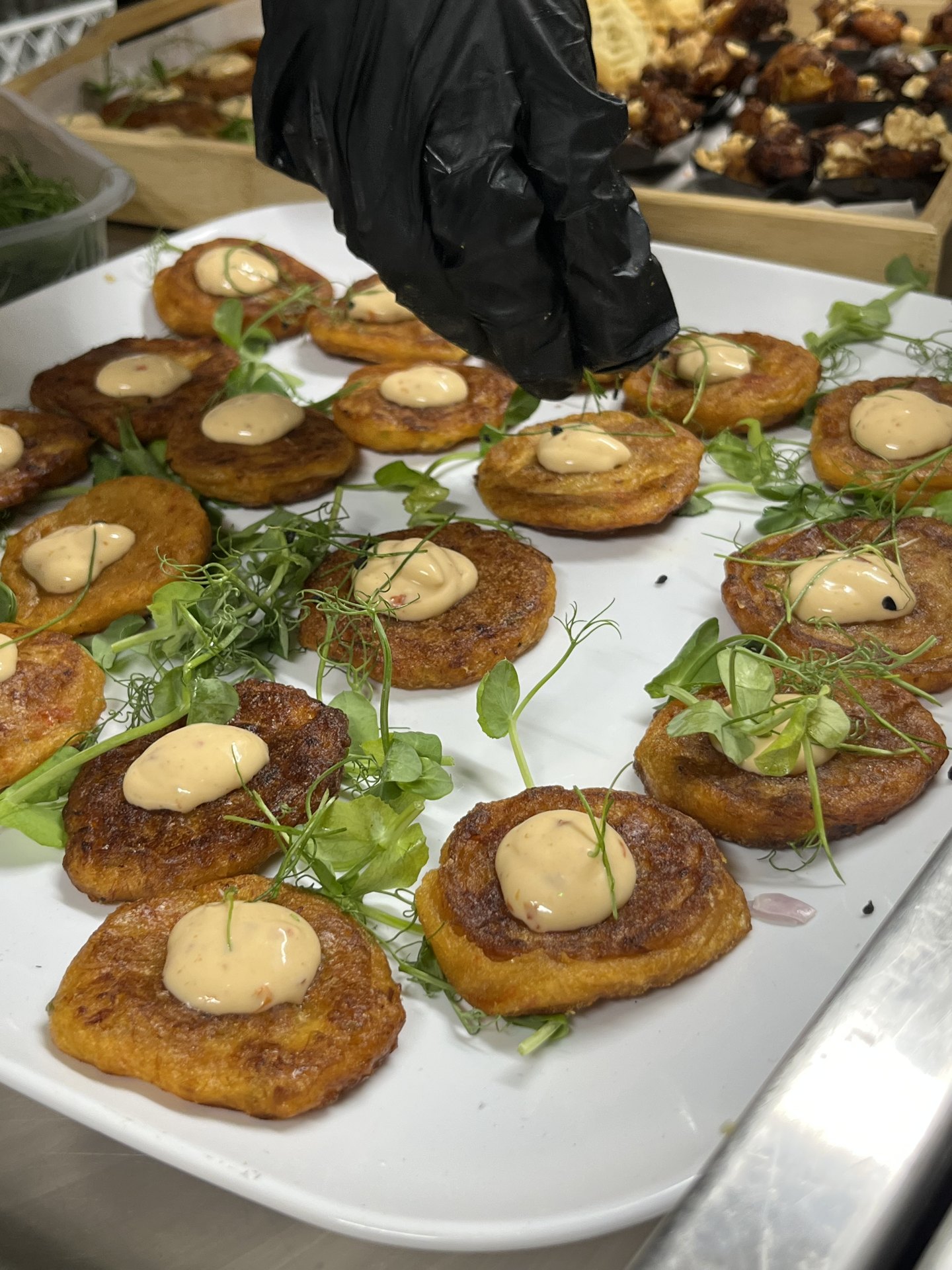 Plantain canapés topped with spiced mayonnaise and micro herbs