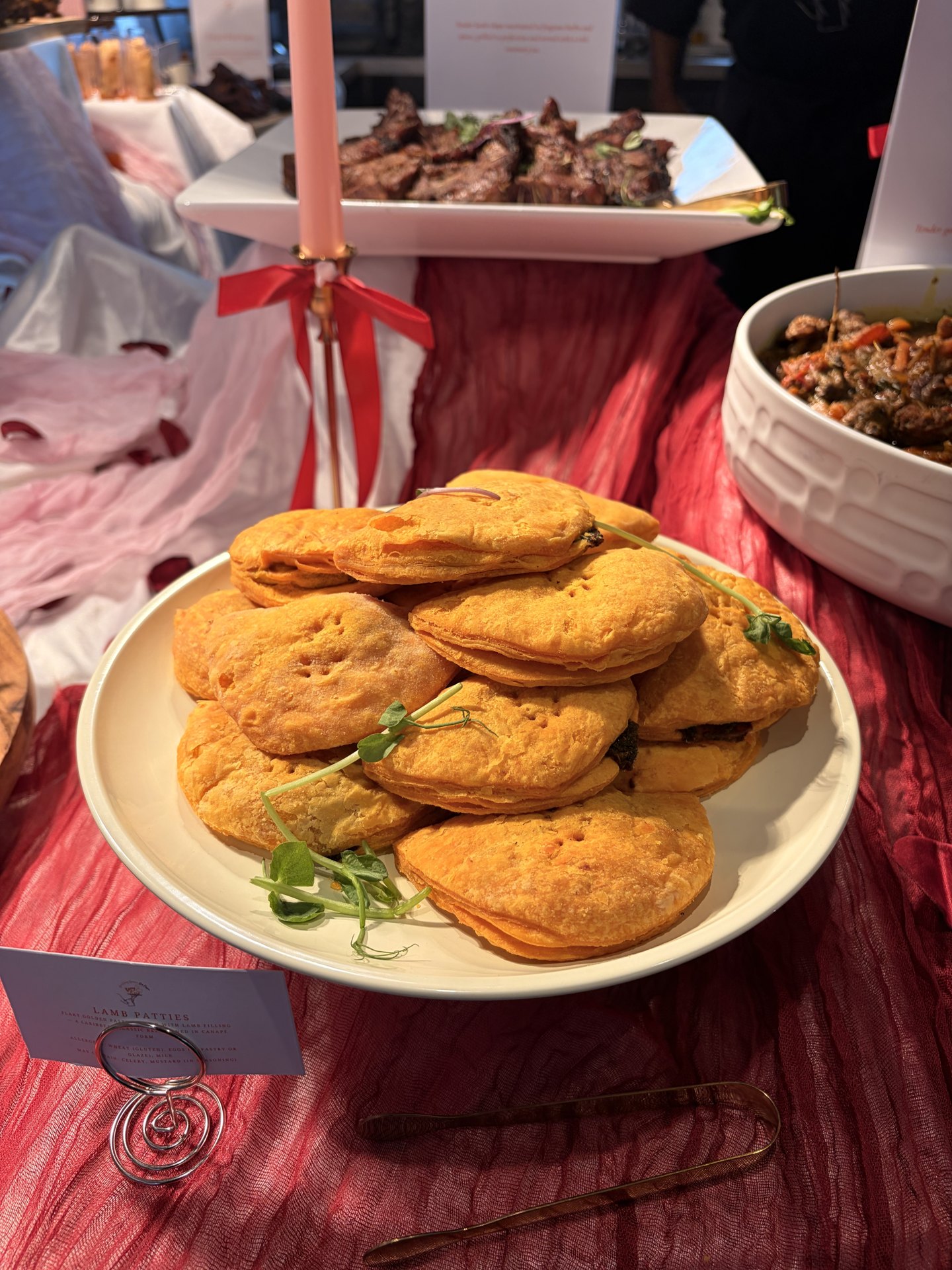 Golden handmade KezzyKooks patties served on a white platter